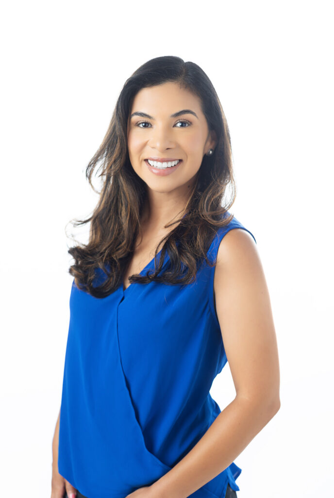 professional headshot of an doctor wearing a blue shirt on white backdrop