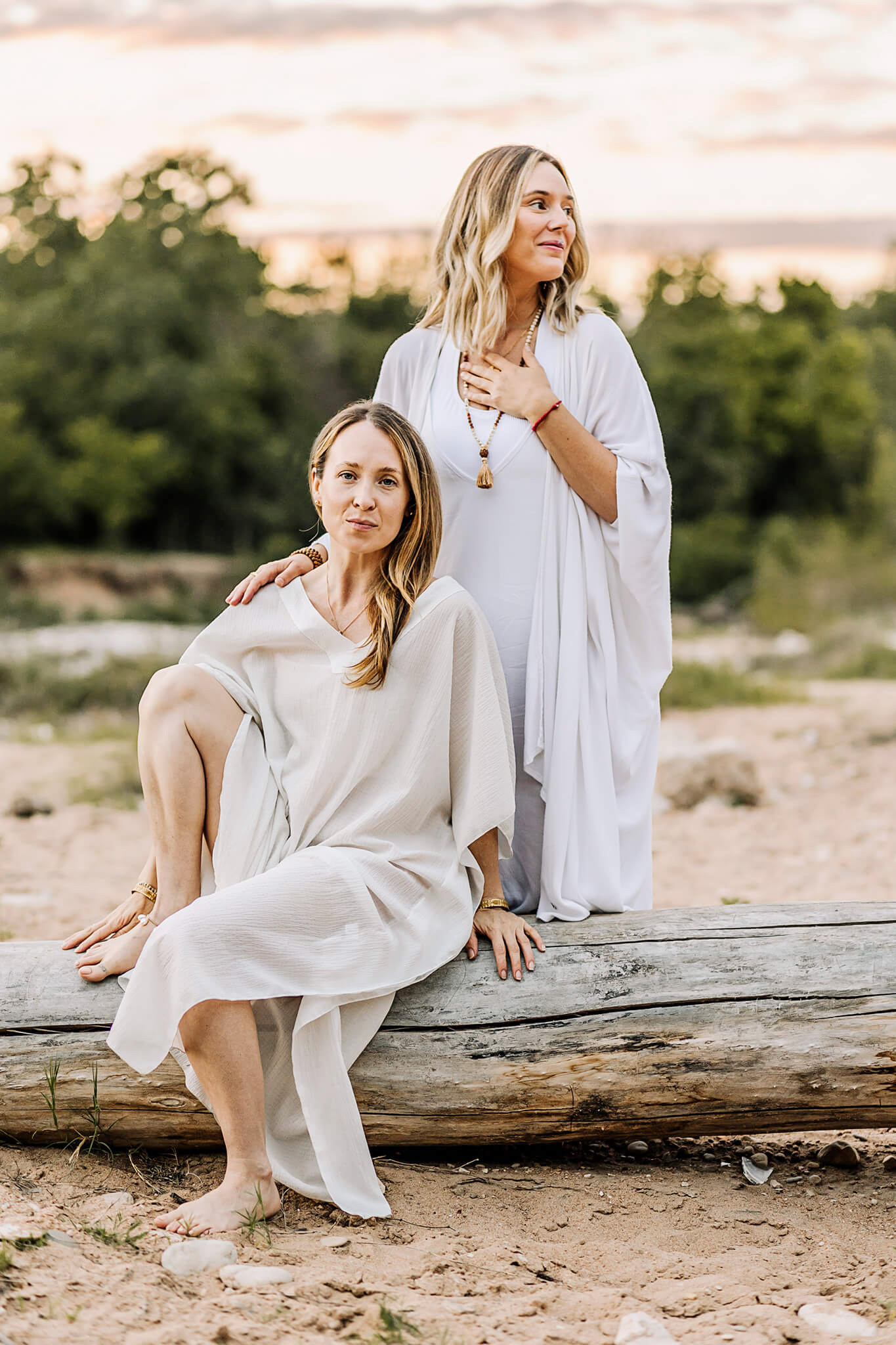 Yoga studio owners pose for a photo outdoors with beautiful sunset for a photoshoot