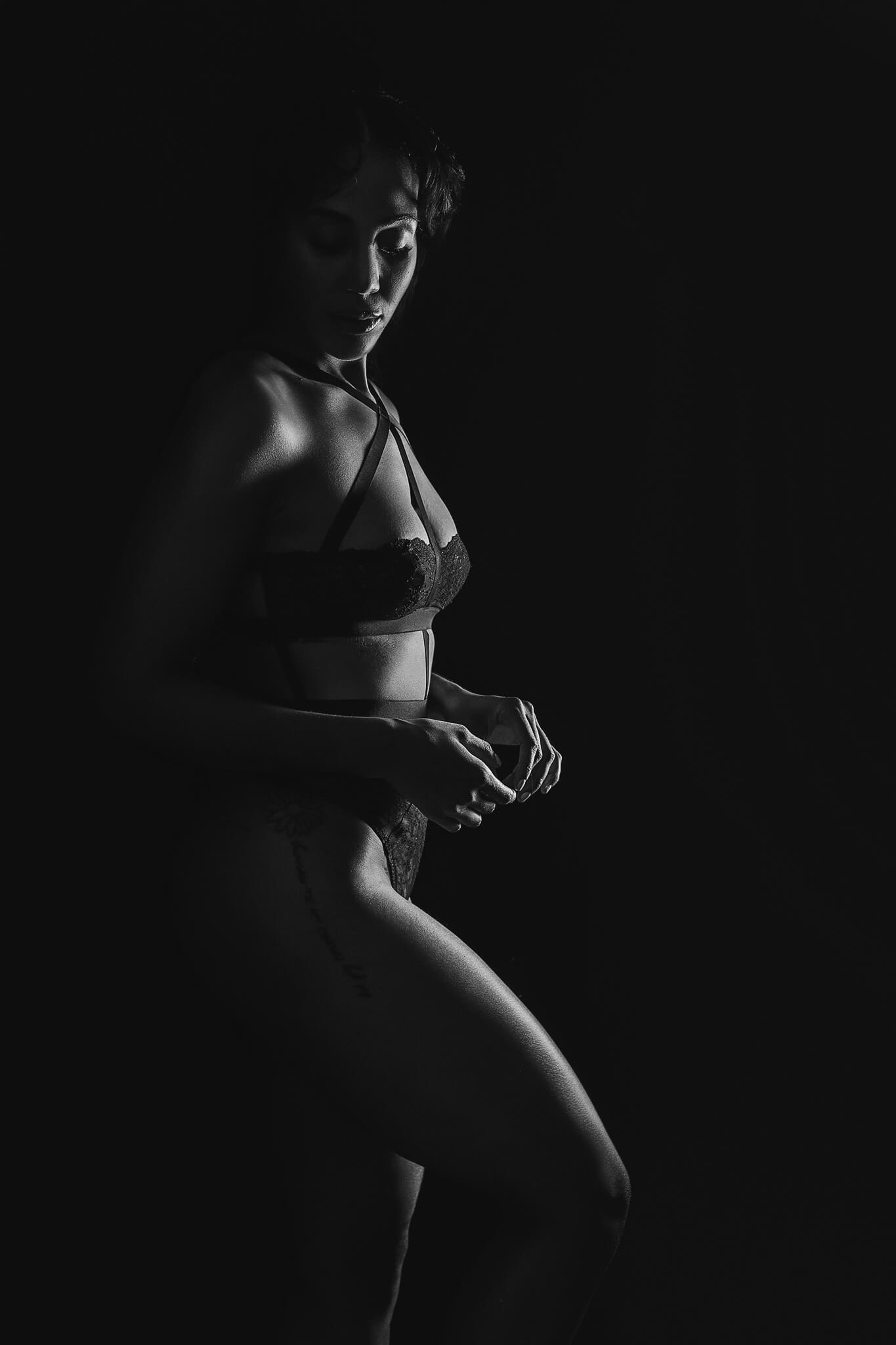 silhouette of a black woman wearing lingerie in an artistic and elegant way