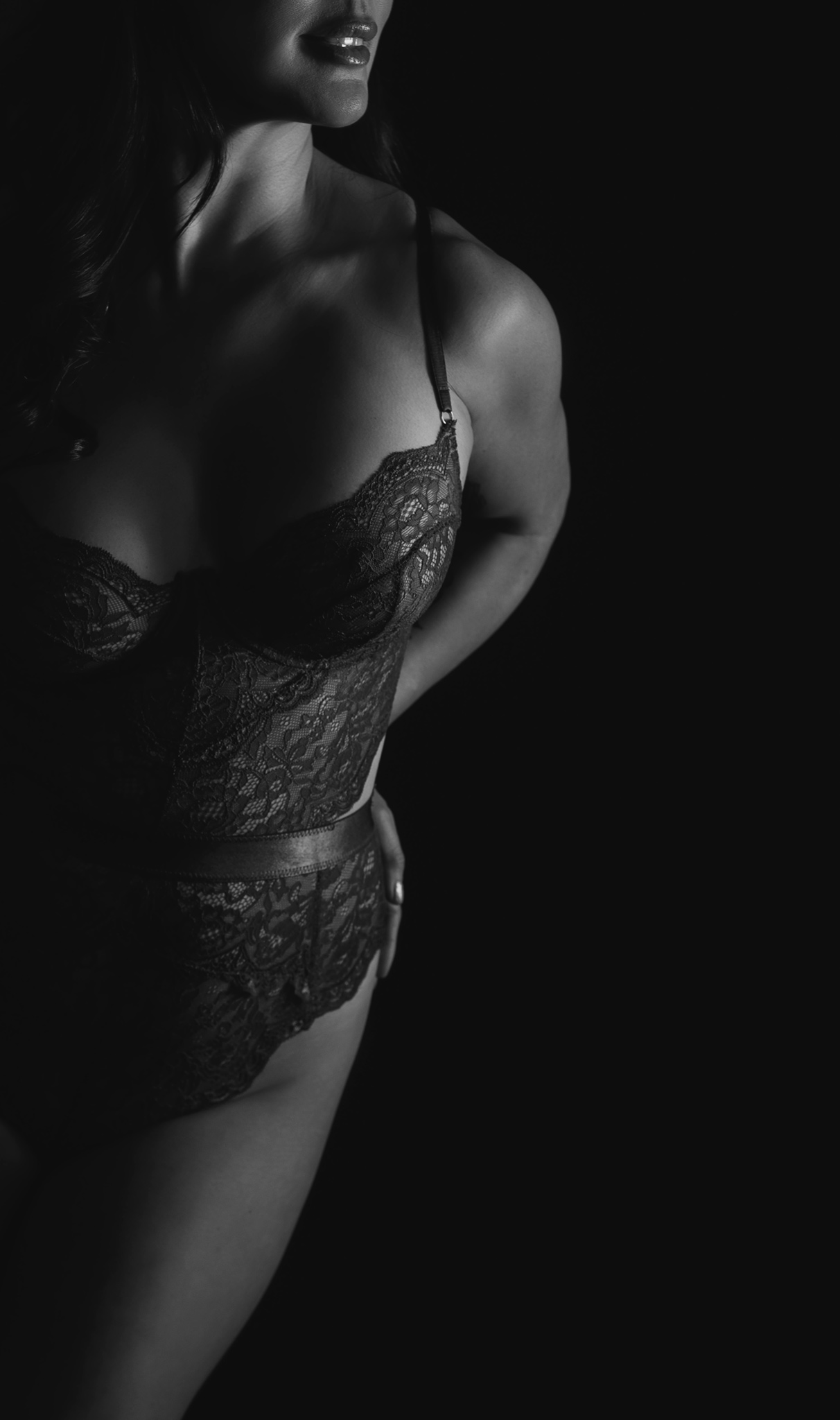 artistic lighting of a woman wearing lingerie and showing only half body in a boudoir session in Austin, Texas