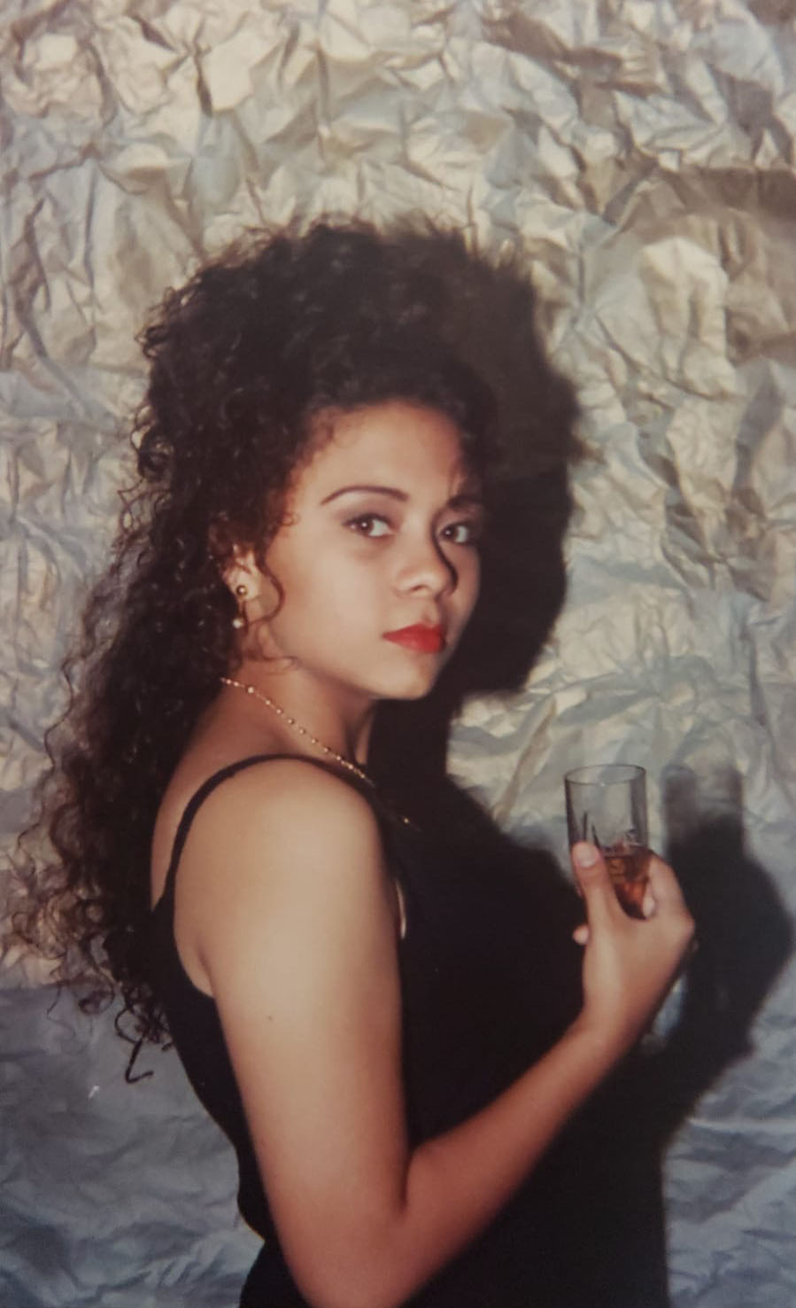 holding a glass of wine for her first photoshoot