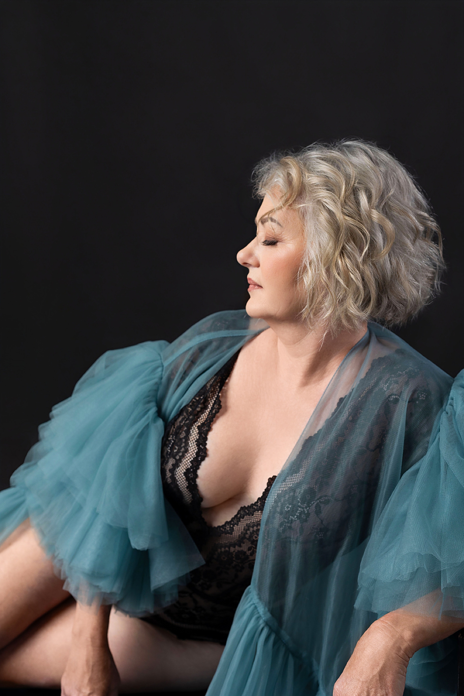 mature woman in fancy blue robe showing why every woman needs boudoir